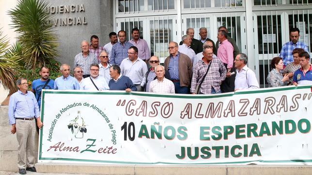 Afectados por el «caso Almazaras de Priego», ayer, ante la puerta de la Audiencia