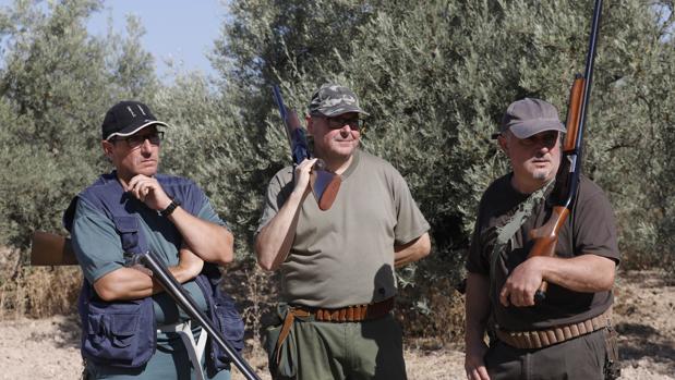 Tres cazadores durante una montería